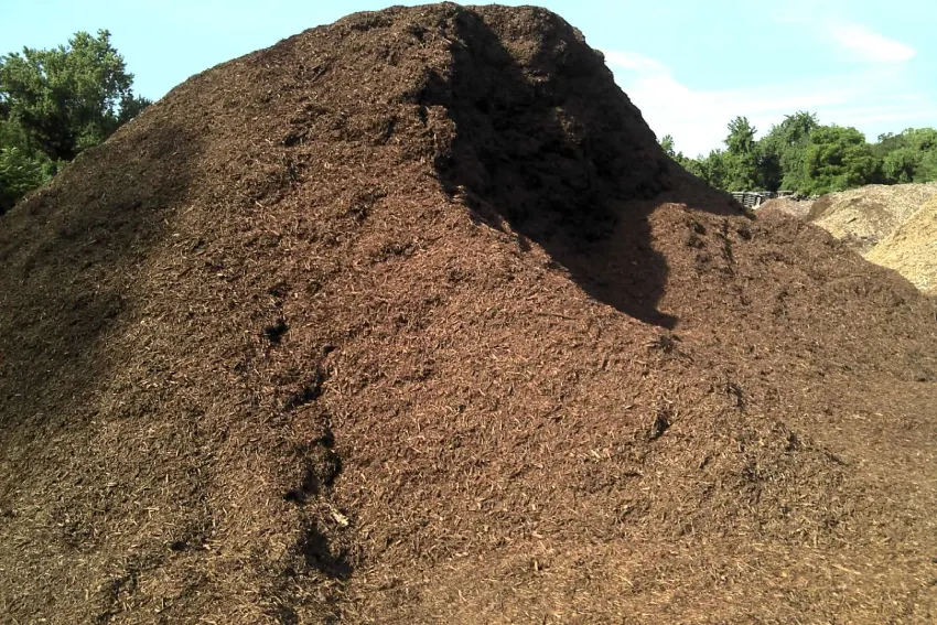 A pile of brown dirt on top of a hill.