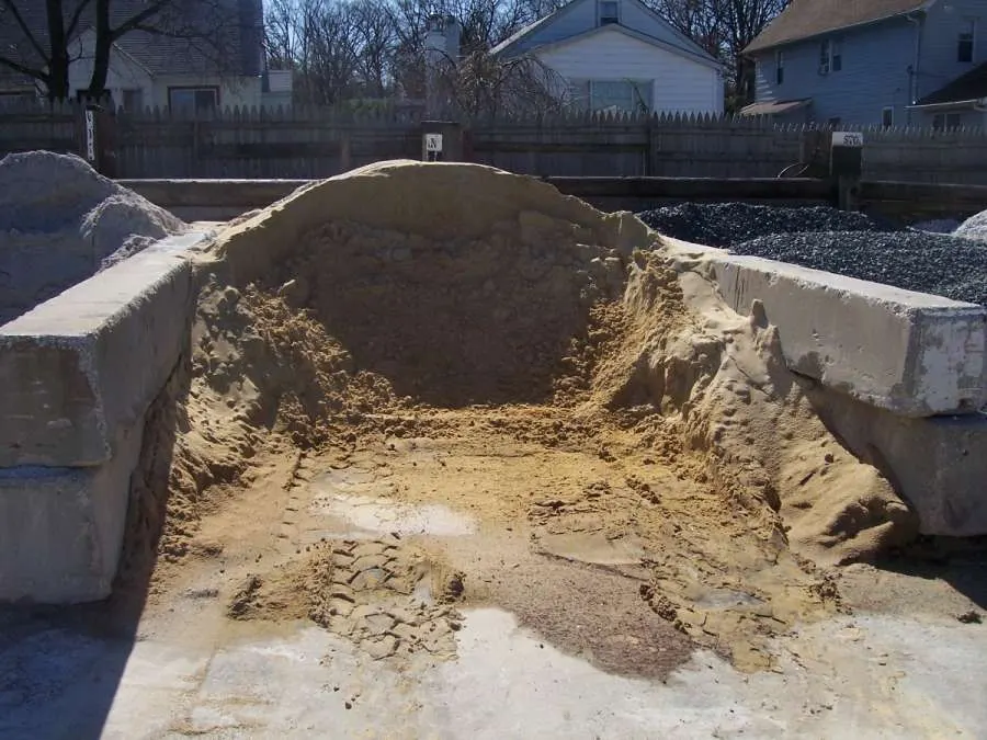 A large pile of dirt in the middle of a yard.