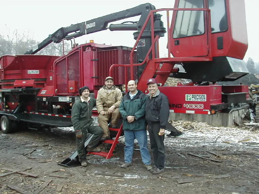 A group of people standing in front of a red machine.